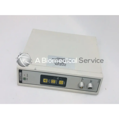 Beige rectangular jedmed globalmed xe30 medical light source with control panel, yellow warning symbols, and two silver knobs