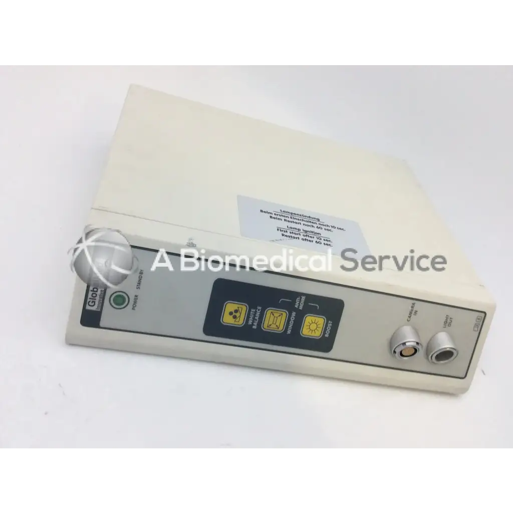 Cream-colored jedmed globalmed xe30 ntsc light source with gray control panel, yellow buttons, silver knobs, and globus branding