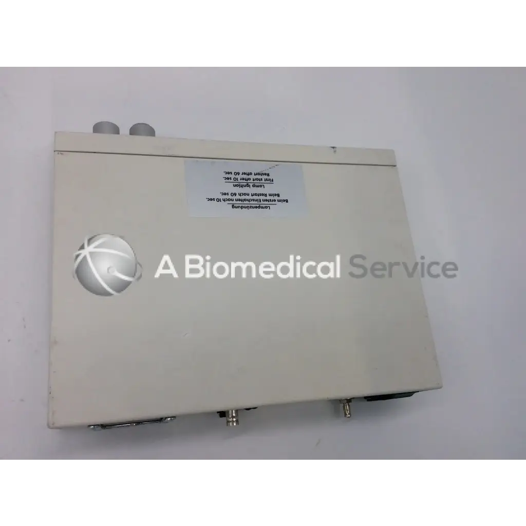 Beige rectangular jedmed globalmed xe30 ntsc light source with silver spherical logo and metallic connectors on sides