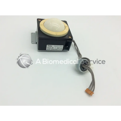 Black kuroda track ball with cream top and beige rubber ring with gray cables and orange connector kanda tsushin kogyo track ball