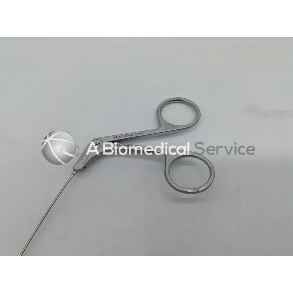 Silver karl storz ehw semi rigid scissors with spherical tip and engraved branding on surgical forceps