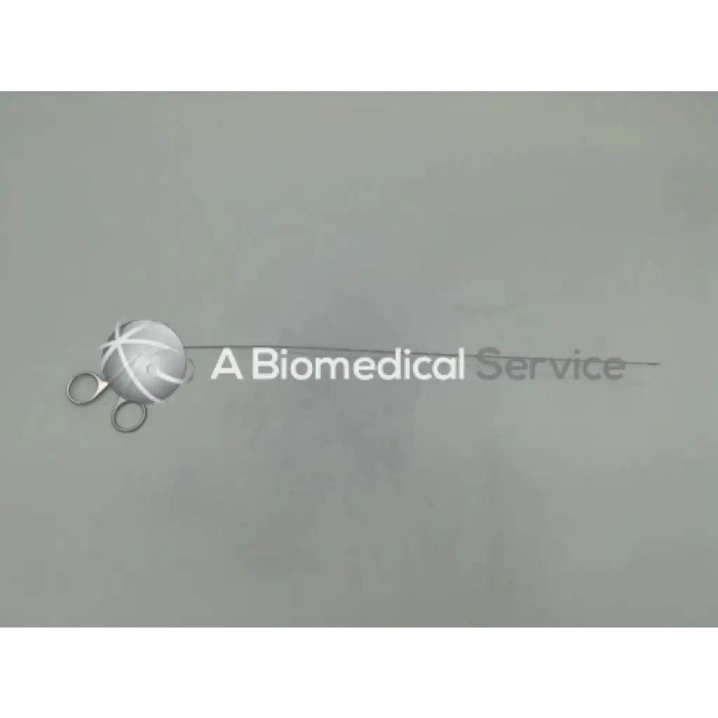 Silver karl storz ehw semi rigid scissors with white cord wrapped spherical handle beside biomedical service text
