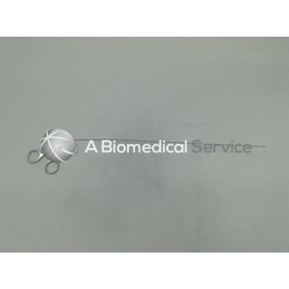 Silver karl storz ehw semi rigid scissors with white cord wrapped spherical handle beside biomedical service text