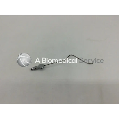 Silver-colored slender metal karl storz handpiece instrument 28035 a with curved tip and small circular head