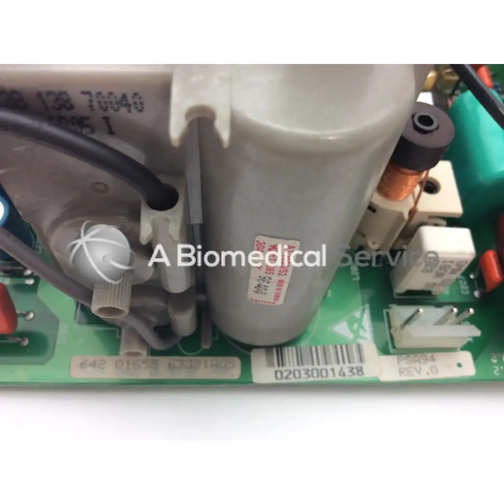 Gray cylindrical capacitor with white label and black text mounted on green circuit board of lares 105 bbce5-3 board