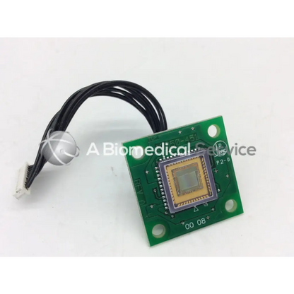 Green rectangular board bbcc1-6 with square sensor module and black cable attached in leica 13950-451 rev a board