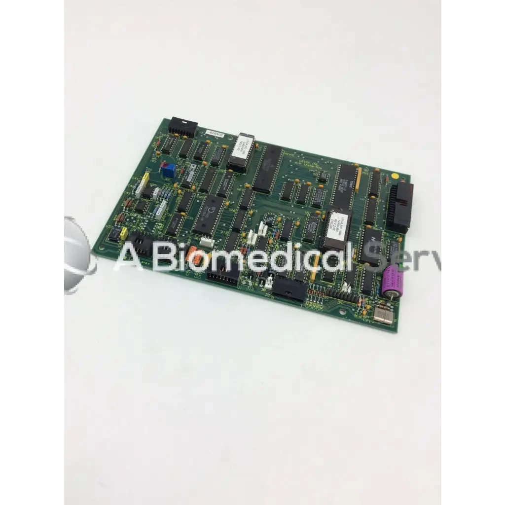 Green rectangular Leica A/N 12450-926 circuit board with black integrated circuits capacitors and connectors