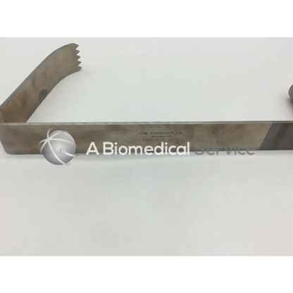 Metallic silver life instruments mcelroy retractor with serrated edge and engraved markings for surgical use