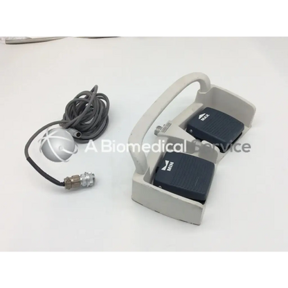 Gray plastic linemaster aquiline harmonic scalpel footswitch with two black max pedals and silver sensor with gray cable