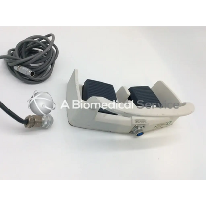 Gray plastic linemaster aquiline harmonic scalpel footswitch with black textured pads and coiled gray cable for ultracision