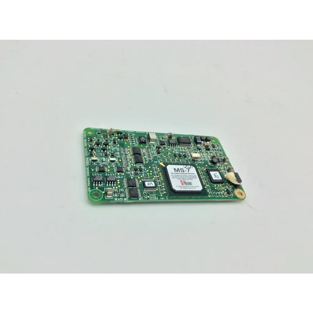 Green pcb board with black integrated circuits and a white label marked ms-7 for masimo spo2 ms-11 device