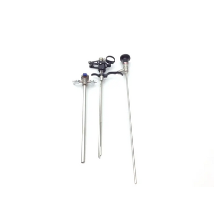 Three surgical instruments with metallic shafts black handles and one purple cap in med-stor delicate instrument tray p7540