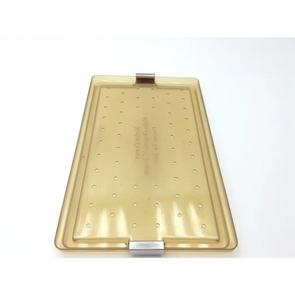 Translucent amber plastic baking tray with grid perforations and metallic clasp hinges for nezhat-dorsey probe tip set
