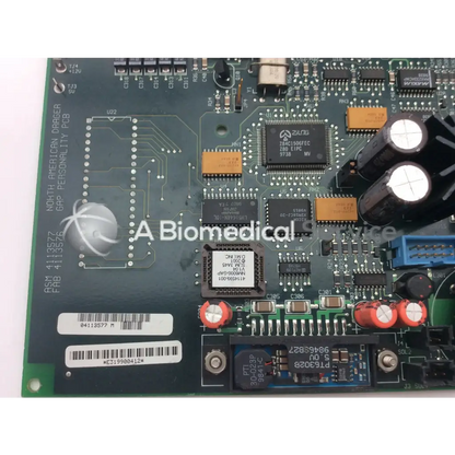 Green printed circuit board with black and orange components red capacitors and white biomedical device label north american drager gap personality pcb