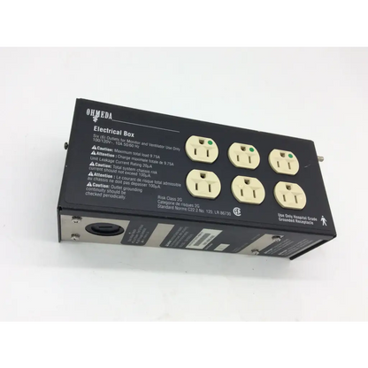 Black ohmeda electrical box with six beige outlets and safety warnings featuring electrical box risk class 100 120v 10a