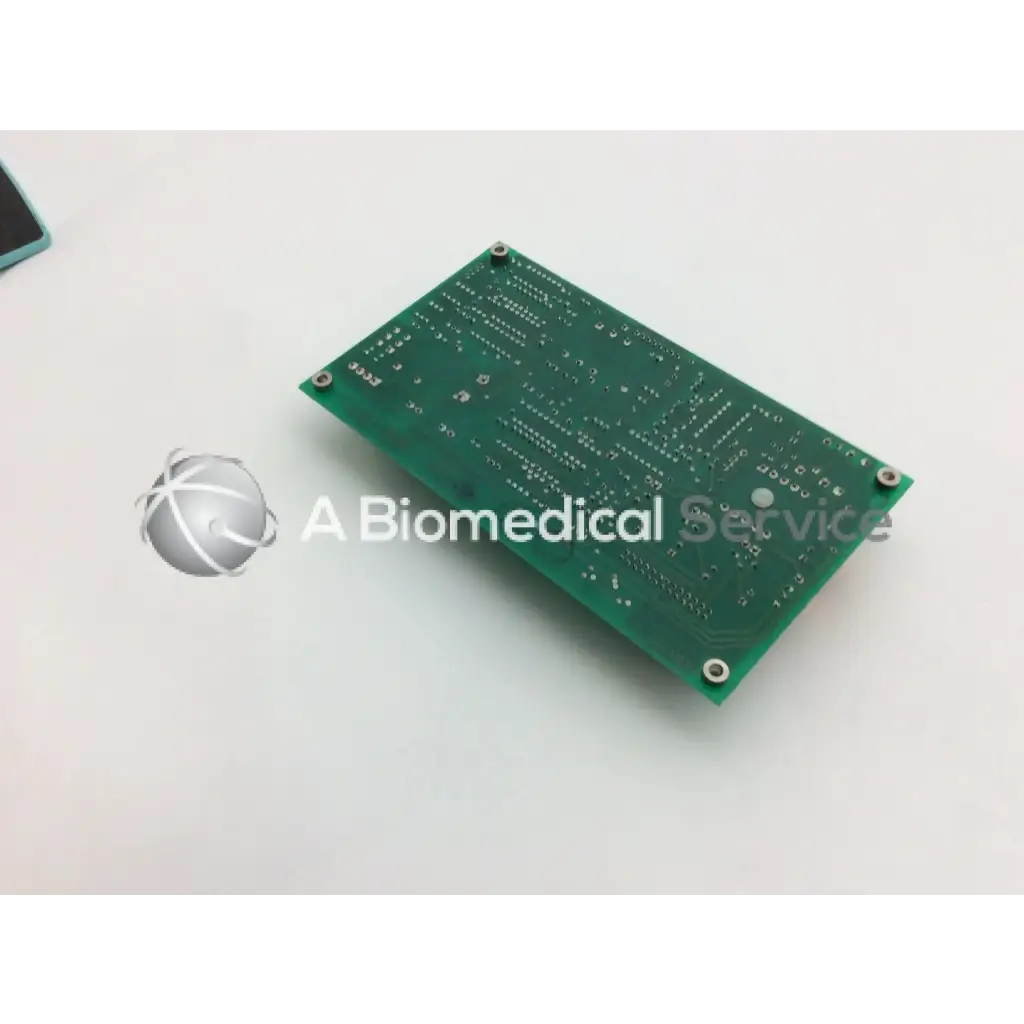 Green rectangular circuit board with silver solder points and four corner screws for ohmeda a124-007 rev product