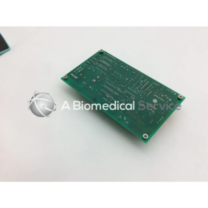 Green rectangular circuit board with silver solder points and four corner screws for ohmeda a124-007 rev product