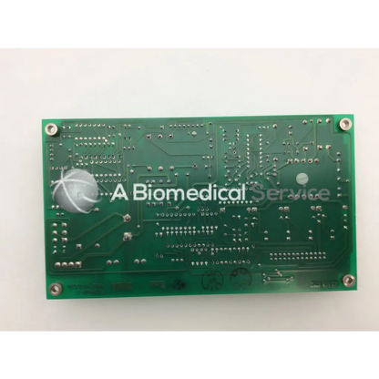 Green rectangular circuit board with silver solder points and component markings for ohmeda a124-007 rev product