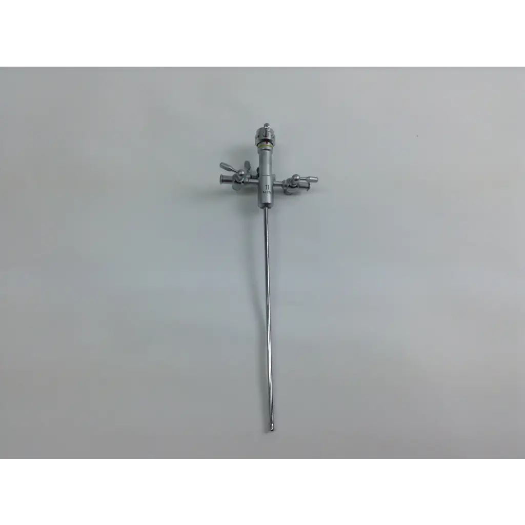 Silver surgical instrument with three adjustable valves from olympus cystoscopy resection set in aesculap sterilization case