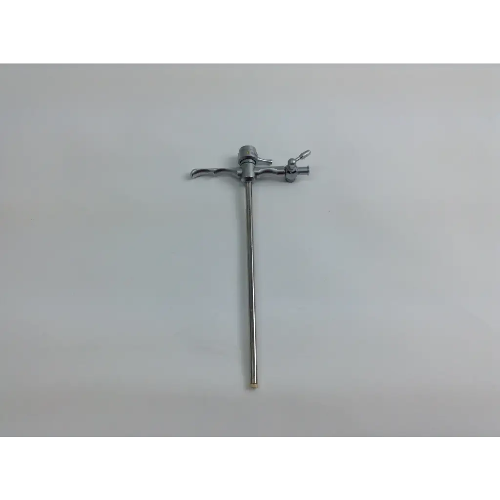 Silver surgical retractor with slender handle and adjustable arms in olympus cystoscopy resection set with aesculap sterilization case
