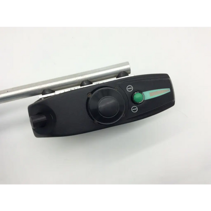 Black plastic control panel with green button and dial and metallic rod on pride mobility jet wheelchair pilot joystick d49637
