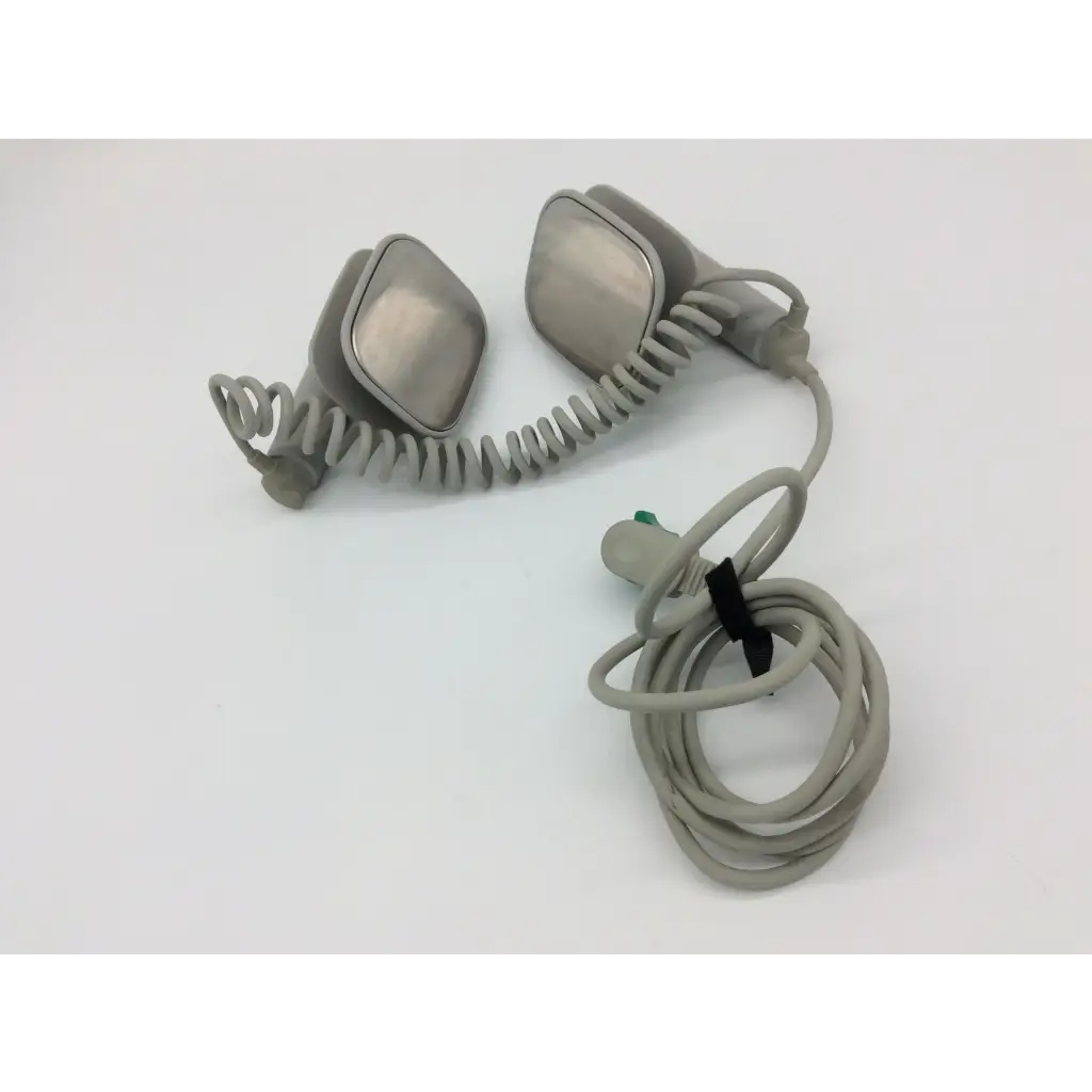Gray coiled philips external hard defibrillator cable with two metallic rectangular headpiece attachments for m3543a