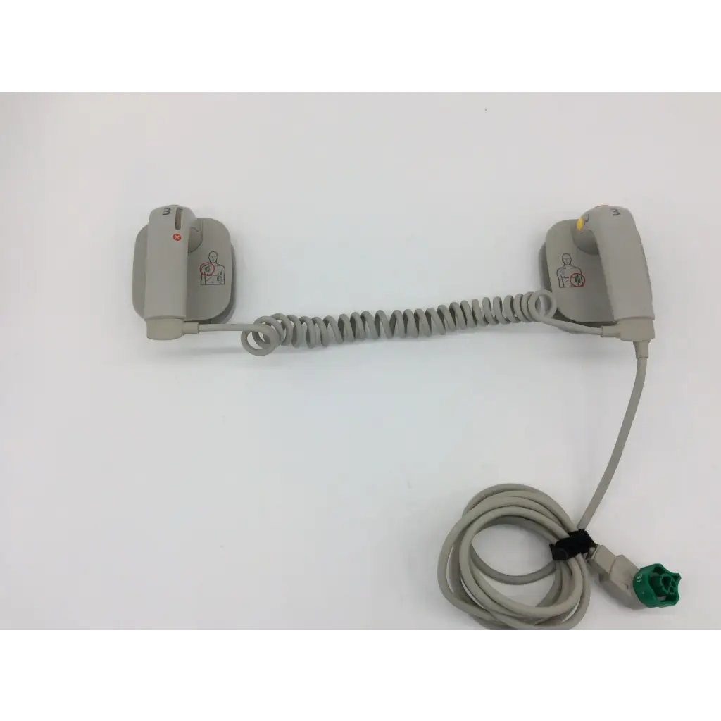 Gray coiled cable connecting two gray aed pads with green connector for philips external hard paddles defibrillator m3543a