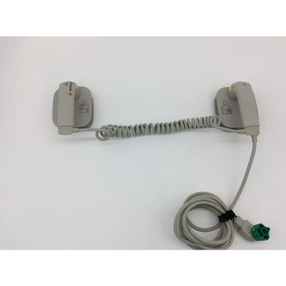 Gray coiled cable connecting two gray aed pads with green connector for philips external hard paddles defibrillator m3543a