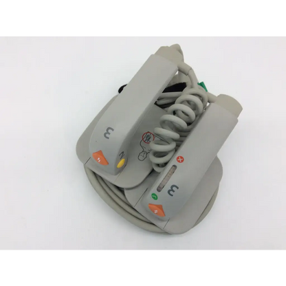 Gray philips external hard paddles defibrillator m3543a with coiled cable and colored indicator buttons