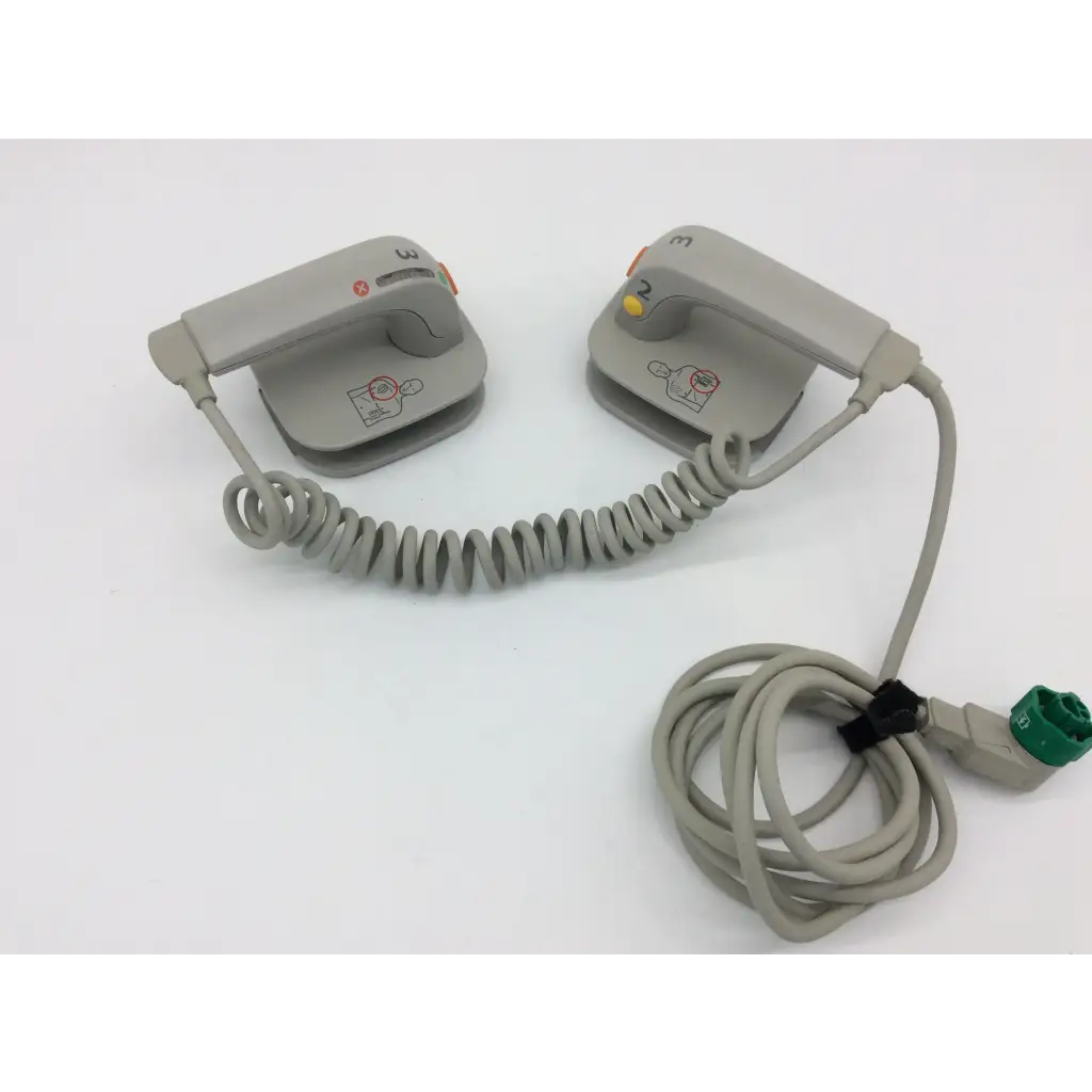 Philips external hard gray plastic defibrillator pads with coiled cables and green connector for emergency use
