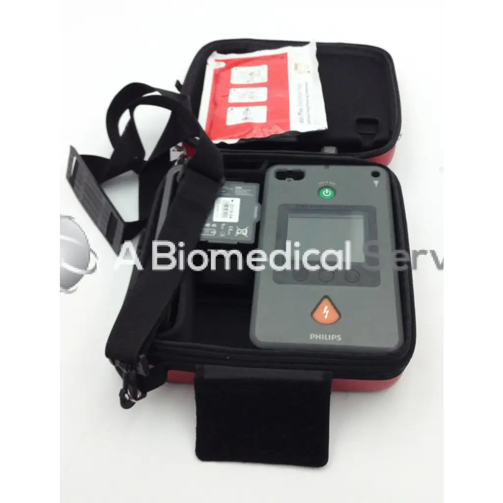 Gray philips heartstart fr3 aed defibrillator with green power button and orange shock indicator in black red case