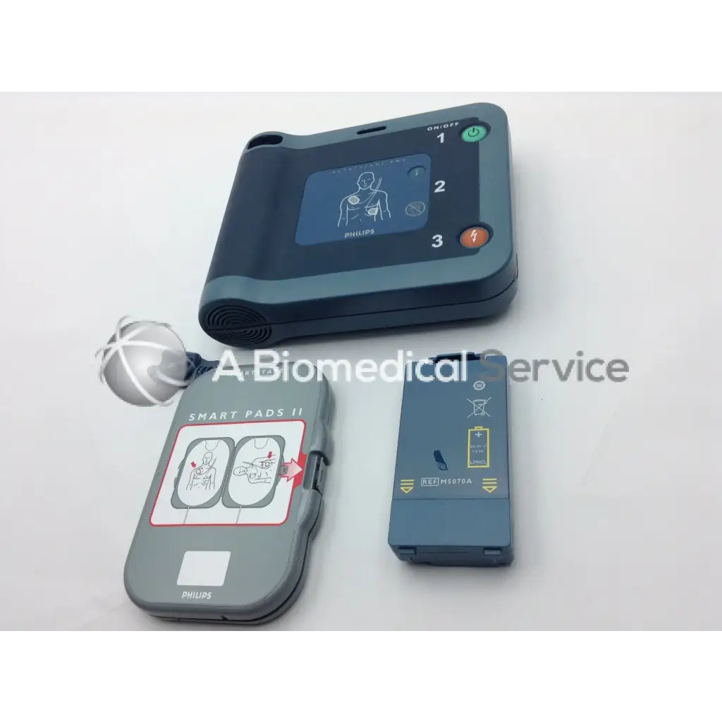 Philips Heartstart FRX AED trainer with gray black casing digital display green orange buttons and Smart Pads II electrodes case