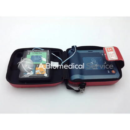Red and black portable philips heartstart frx aed trainer case with defibrillator and instructional guide for emergency use