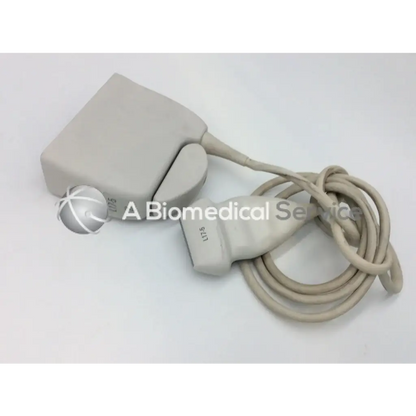 Beige philips l17-5 linear array ultrasound transducer probe with coiled cable and labeled array ultrasound transducer connector