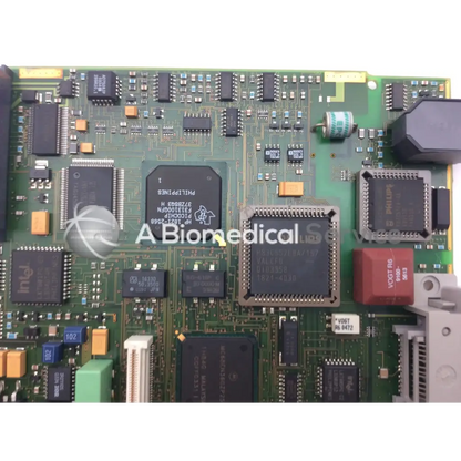 Green circuit board with black integrated circuits orange and blue capacitors and red vogt r6 component patient monitor circuit board