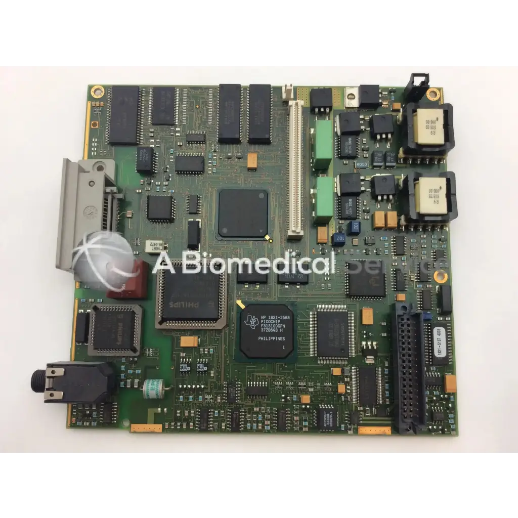 Green patient monitor circuit board with black and silver components featuring philips hp 182-056b chip