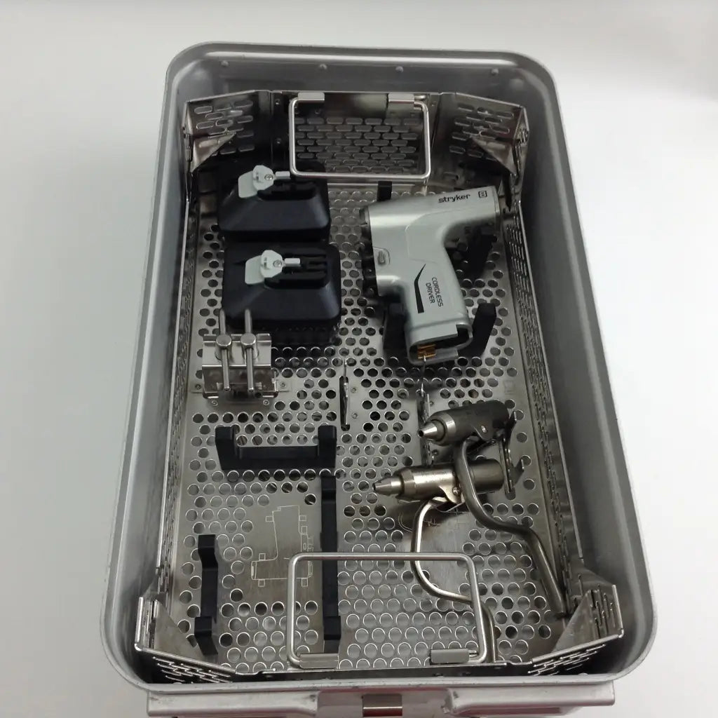 Gray stryker system 8 cordless driver set with a variety of surgical tools in an aesculap case tray