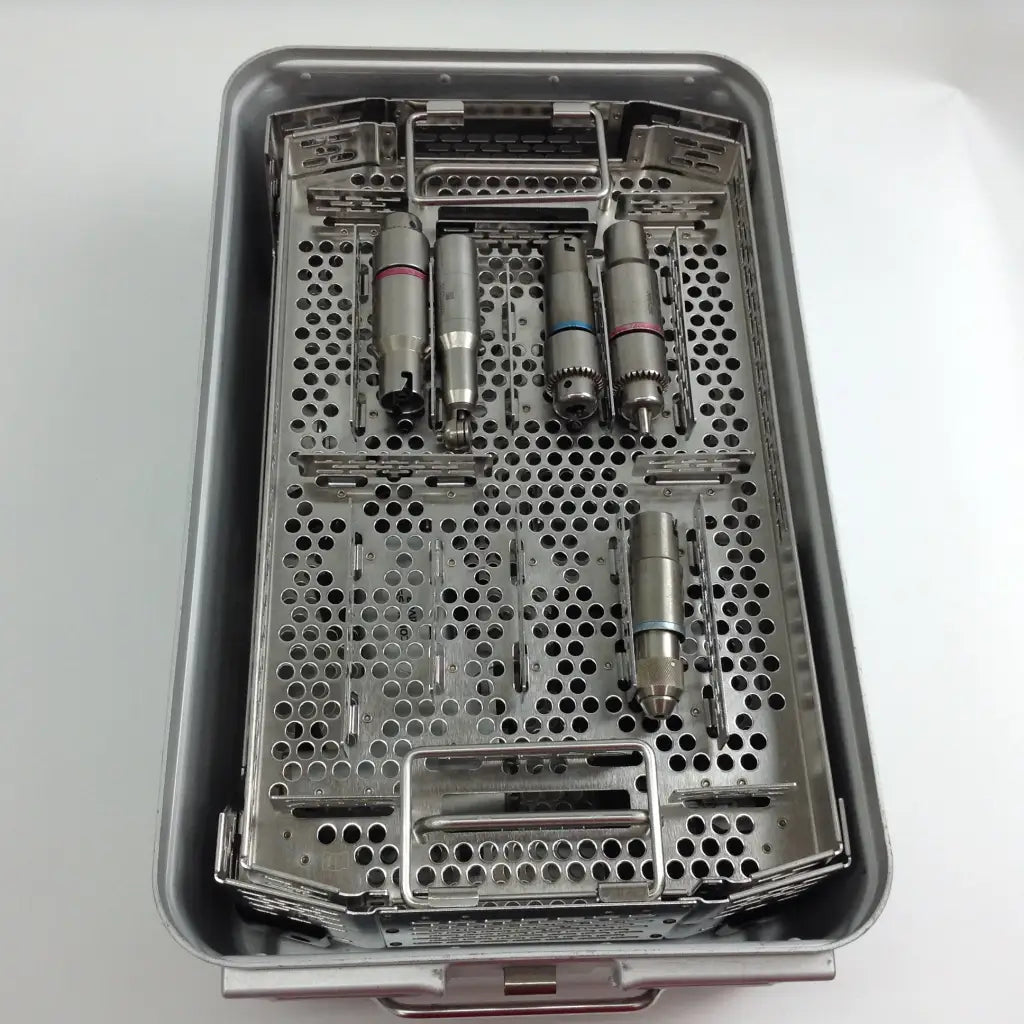 Sterilized metallic dental handpieces with colored bands in a stryker system 8 cordless driver set aesculap case