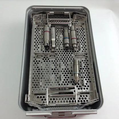 Sterilized metallic dental handpieces with colored bands in a stryker system 8 cordless driver set aesculap case