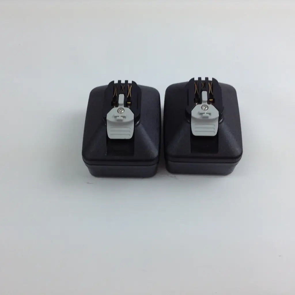 Black rectangular camera flash triggers with gray plastic clips and metallic contacts for stryker system 8 cordless driver set aesculap case
