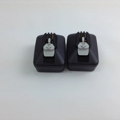 Black rectangular camera flash triggers with gray plastic clips and metallic contacts for stryker system 8 cordless driver set aesculap case