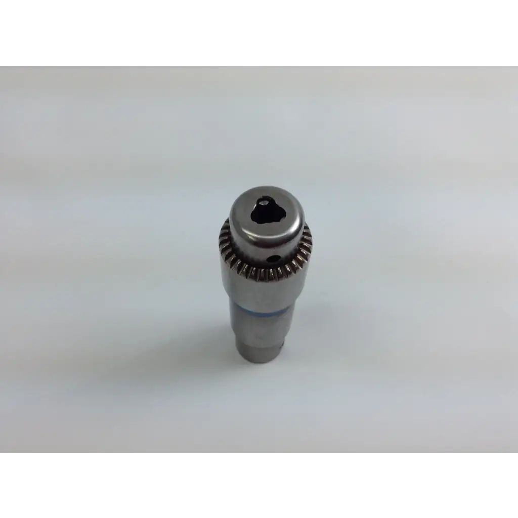 Silver metallic drill chuck with gear-like ridged collar and hexagonal drive in stryker system 8 cordless driver set aesculap case