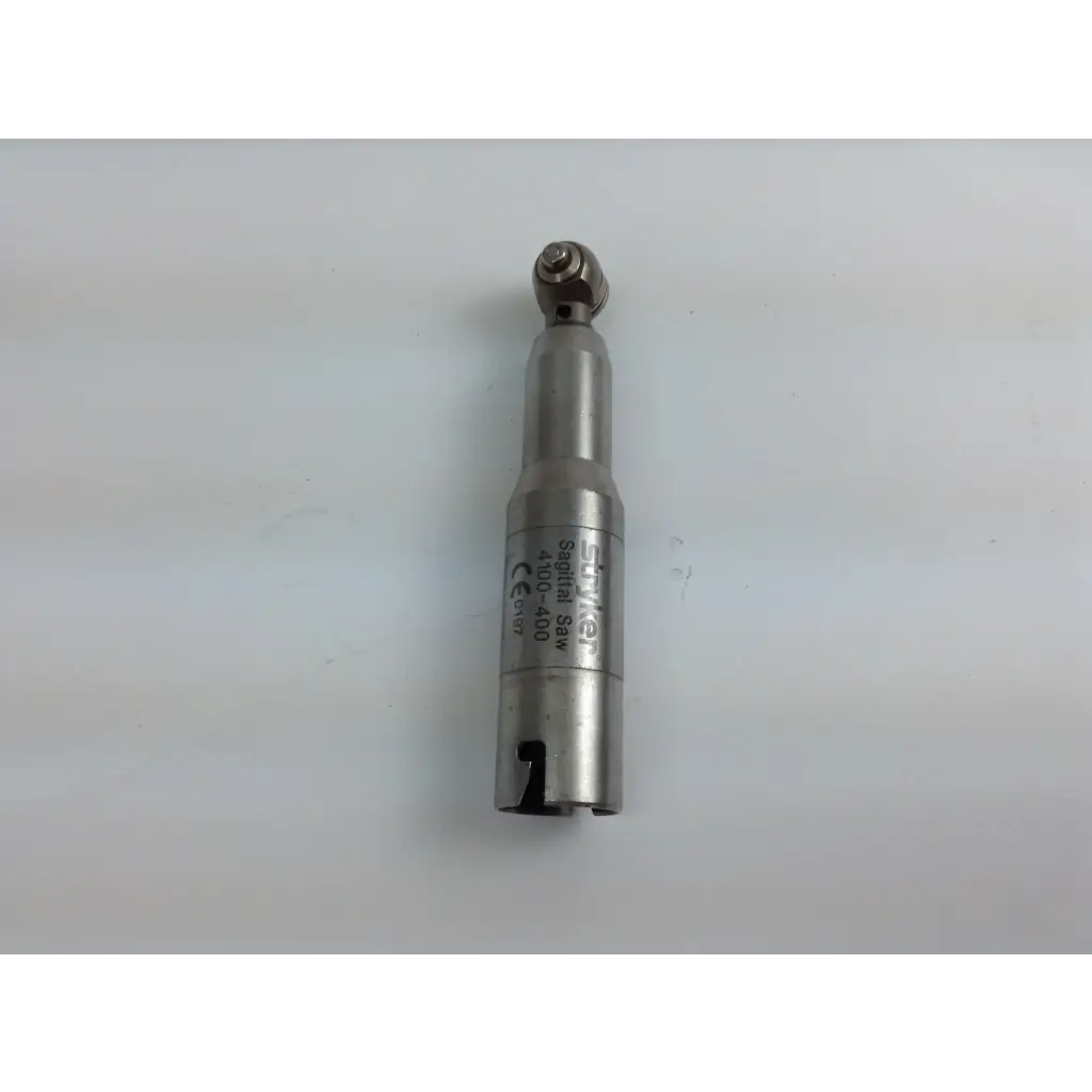 Silver metallic scharf cordless driver with cylindrical body and rounded tip in stryker system 8 driver set with aesculap case