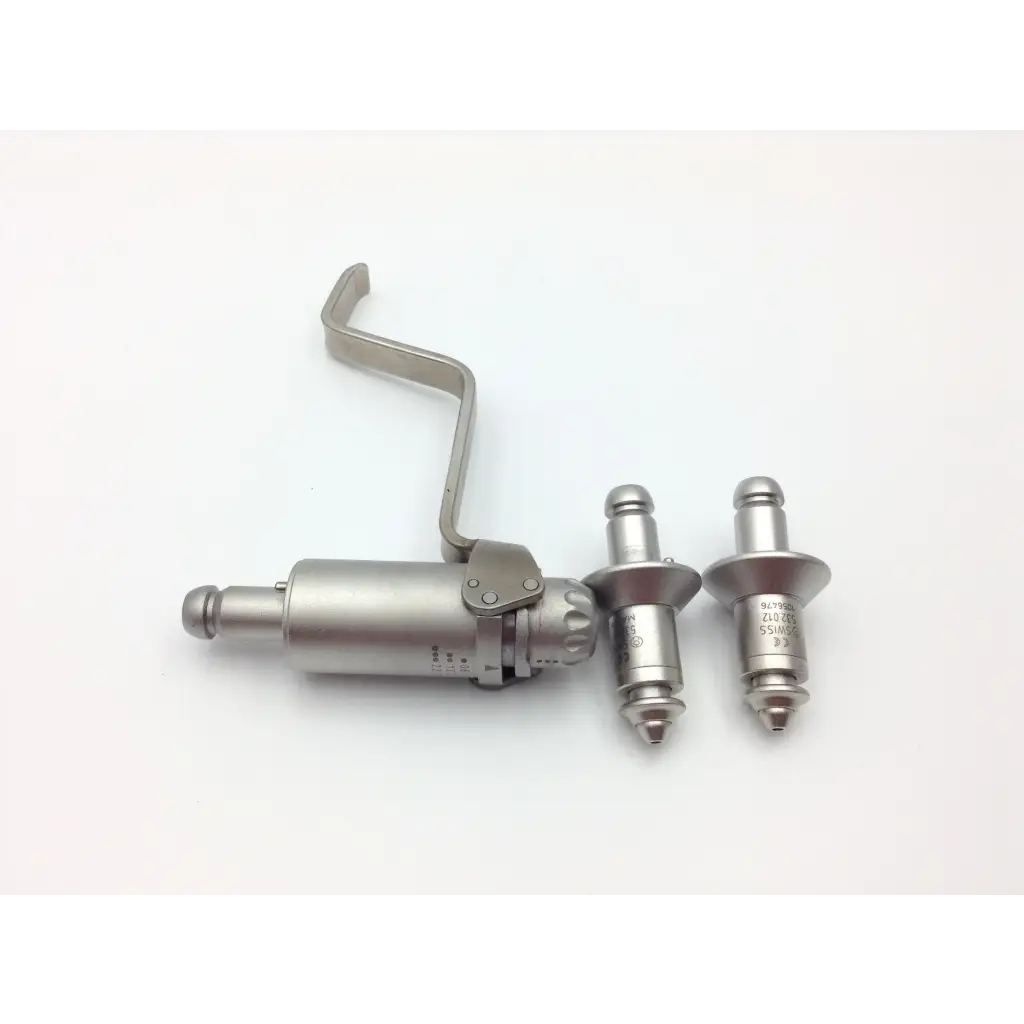 Silver-colored metal rivet gun with two rivets beside it for swiss synthes small battery power drive set with case