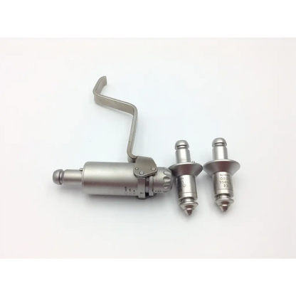 Silver-colored metal rivet gun with two rivets beside it for swiss synthes small battery power drive set with case