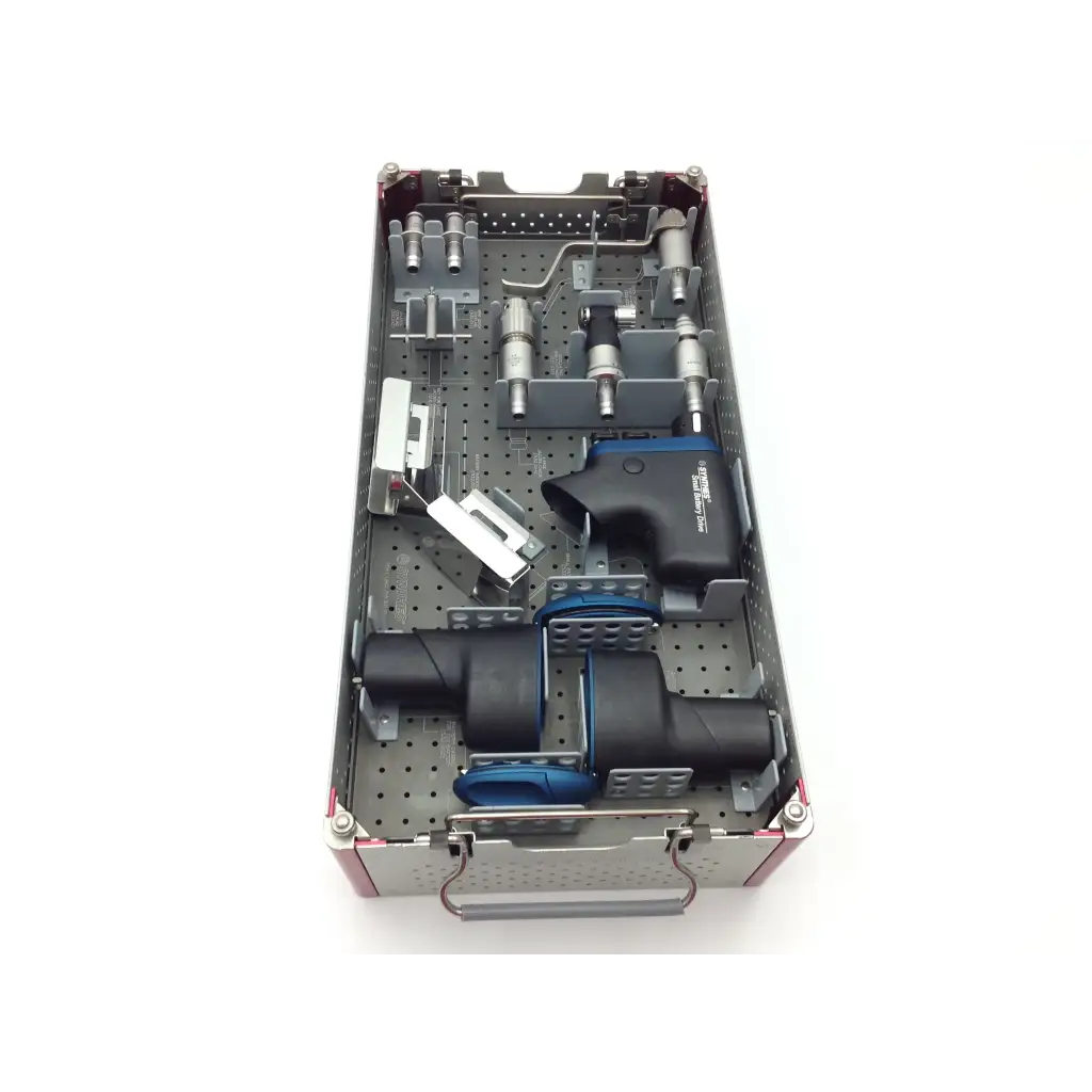 Silver and black swiss synthes small battery power drive surgical instrument kit with blue accents in perforated metal tray