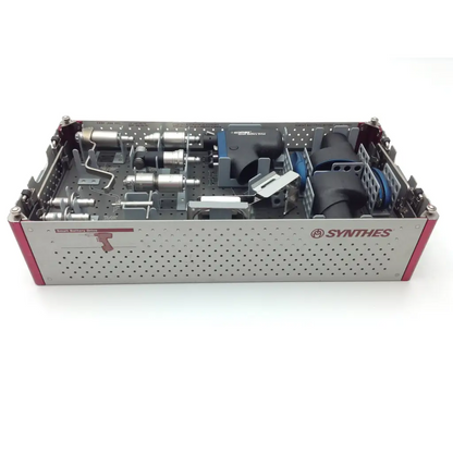 Silver perforated metal swiss synthes small battery power surgical instrument tray with red accents and tools