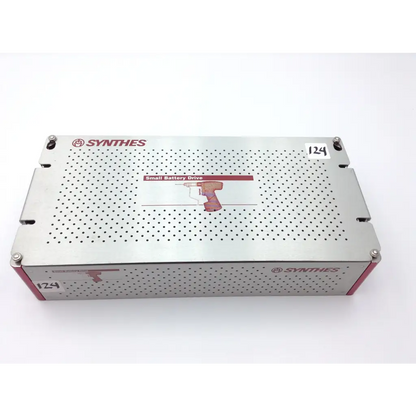 Silver perforated metal swiss Synthes small battery power drive with red accents in a compact case for battery drive use