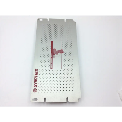 Silver perforated metal panel with red synthes logo and small battery drive for swiss synthes small battery power set
