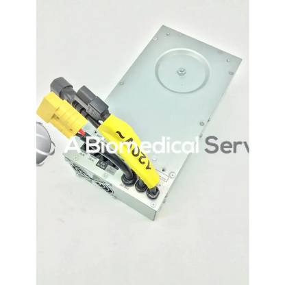 Silver metal tripp lite hc150sl medical cart power supply 150w 120v with yellow and black cables attached